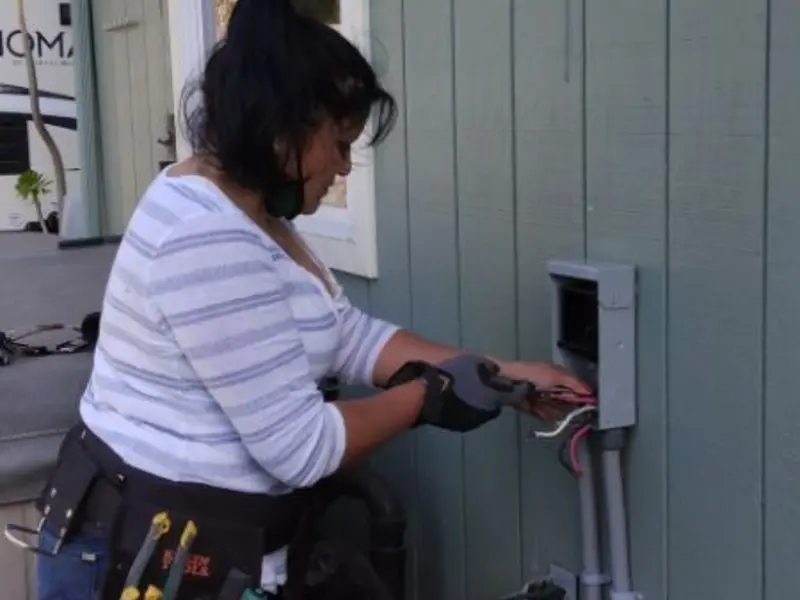 Licensed electrician wiring an exterior subpanel in Oxford